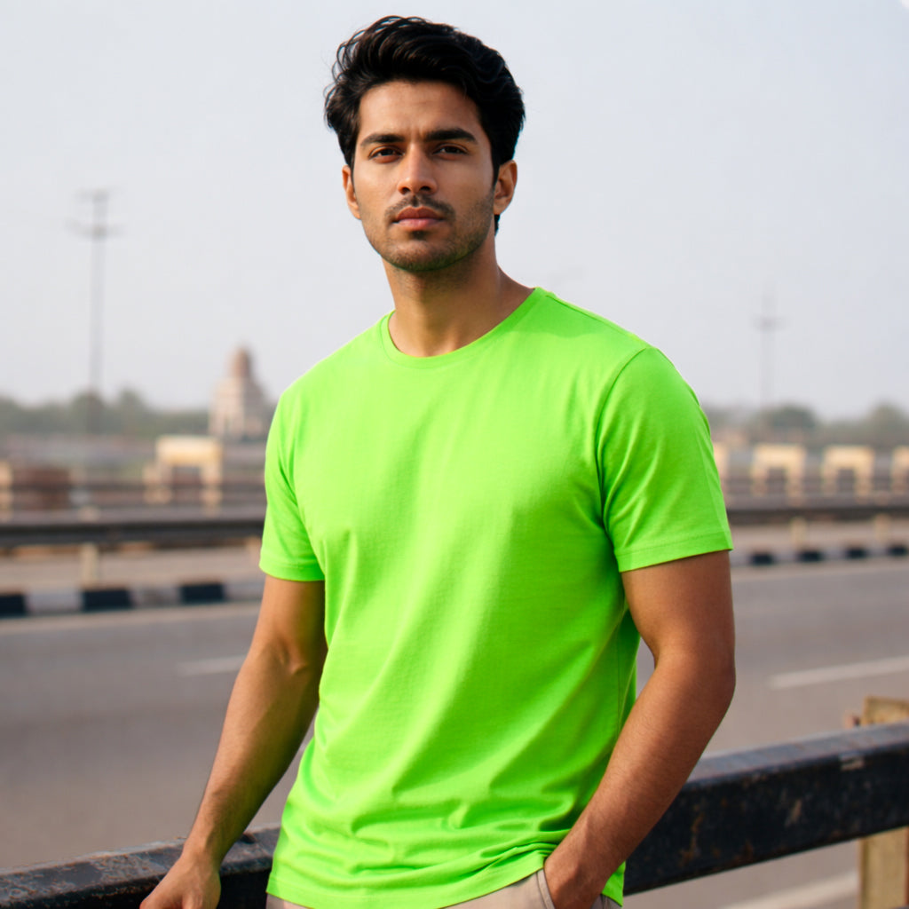 Male model wearing a liril green t-shirt standing near a highway. Plain Liril Green Men's T-shirt by Paryatak Travel Shop.