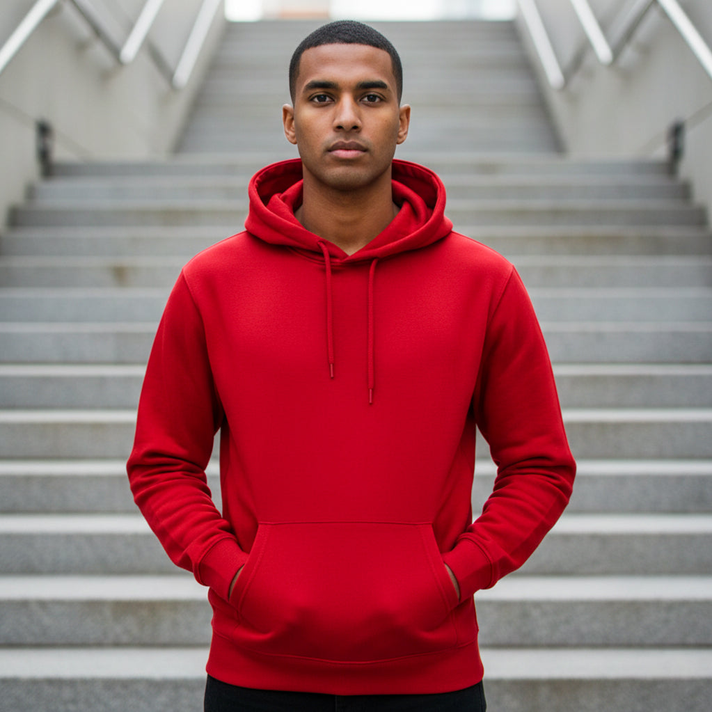 Male model wearing a red hoodie standing on the stairs. Plain Red Hoodie by Paryatak Travel Shop.